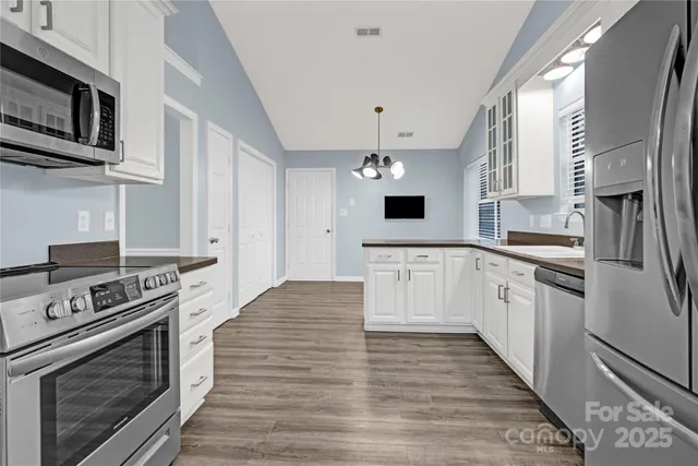 a kitchen with stainless steel appliances granite countertop a stove and a refrigerator