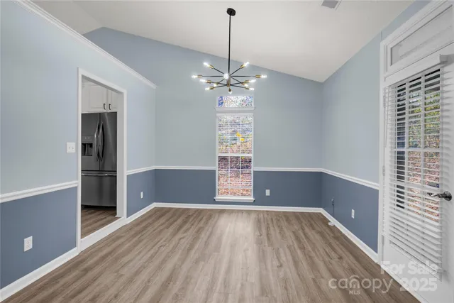 a view of a room with window wooden floor and chandelier