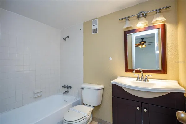 a bathroom with a sink toilet a mirror and shower