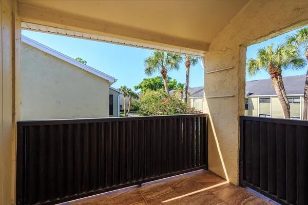 a view of balcony with wooden floor