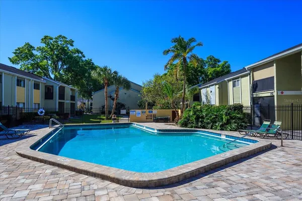 a view of a house with swimming pool and sitting area