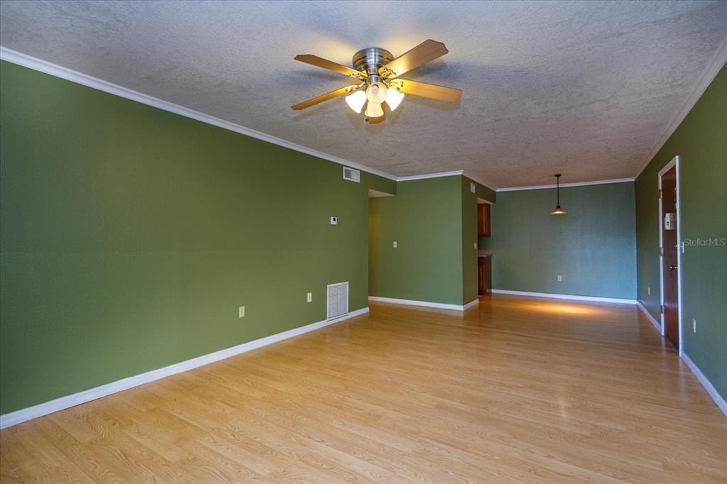 908 Lake Destiny Road, Unit E Altamonte Springs, FL 32714 - Photo 7 of 20 a view of an empty room with a chandelier fan and a window