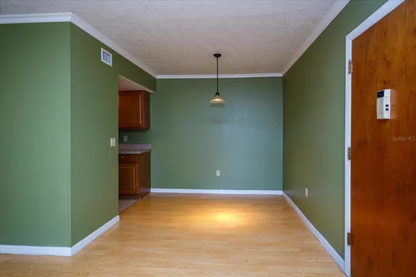 a view of empty room with window and fan