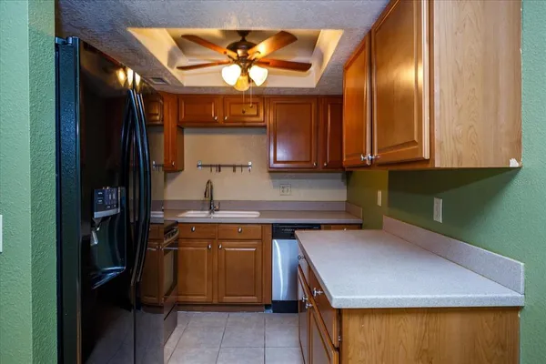 a kitchen with a sink a stove and cabinets