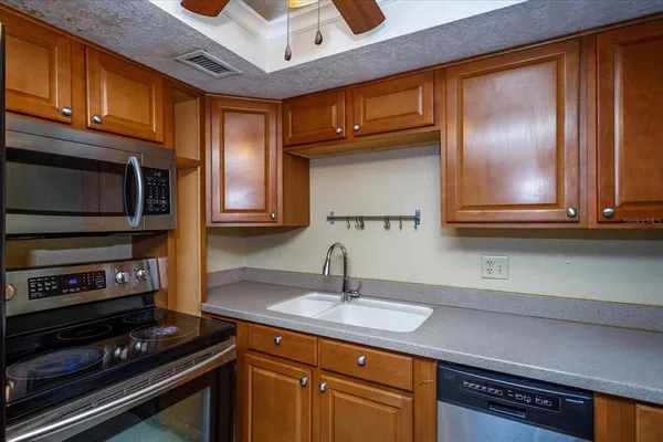 a kitchen with stainless steel appliances granite countertop a stove and a microwave