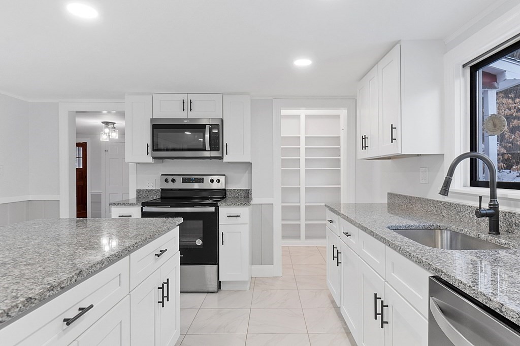 560 County Road Ashby, MA 01431 - Photo 11 of 40 a kitchen with granite countertop a sink and stainless steel appliances