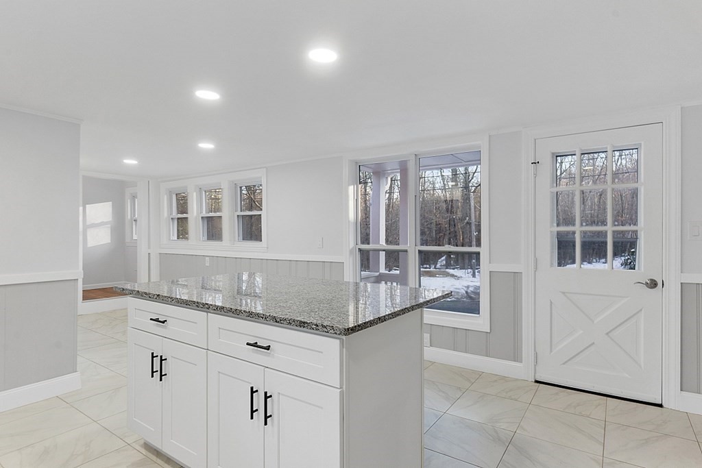 560 County Road Ashby, MA 01431 - Photo 12 of 40 a kitchen with granite countertop a sink and white cabinets