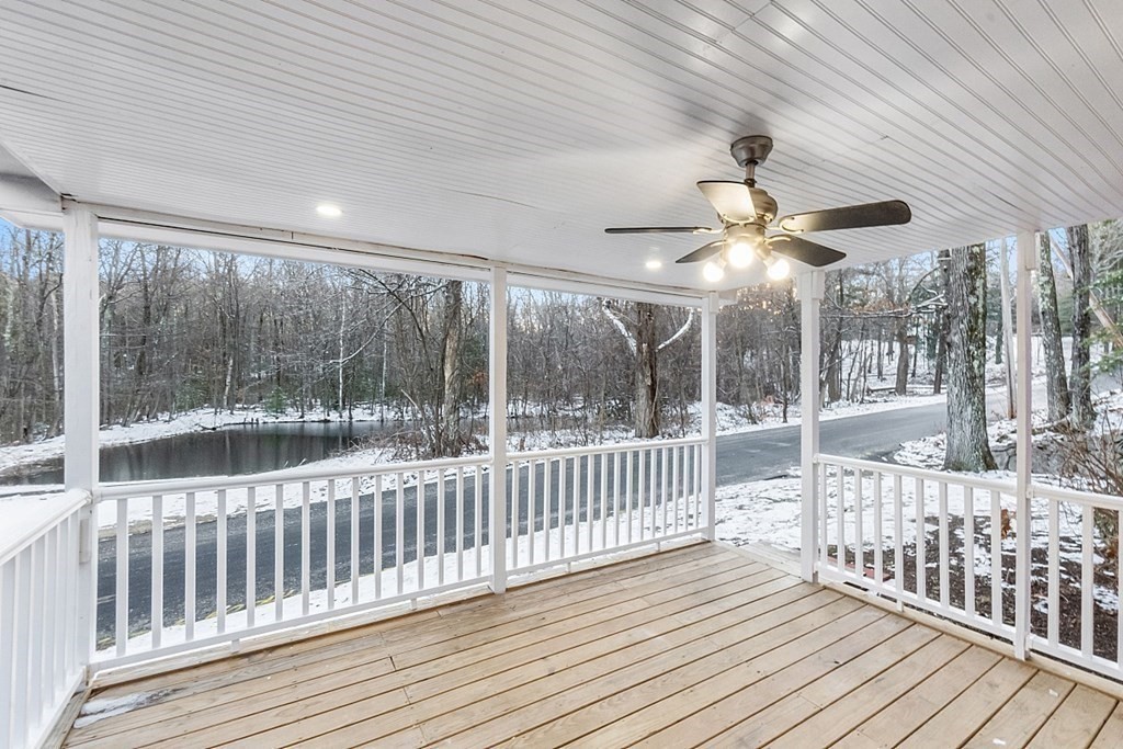 560 County Road Ashby, MA 01431 - Photo 31 of 40 a view of a porch with wooden floor and iron stairs