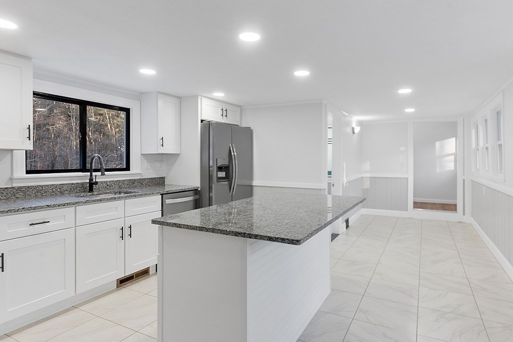 560 County Road Ashby, MA 01431 - Photo 5 of 40 a kitchen with stainless steel appliances granite countertop a sink and a refrigerator