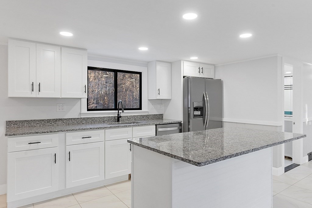 560 County Road Ashby, MA 01431 - Photo 6 of 40 a kitchen with granite countertop a sink a center island and stainless steel appliances