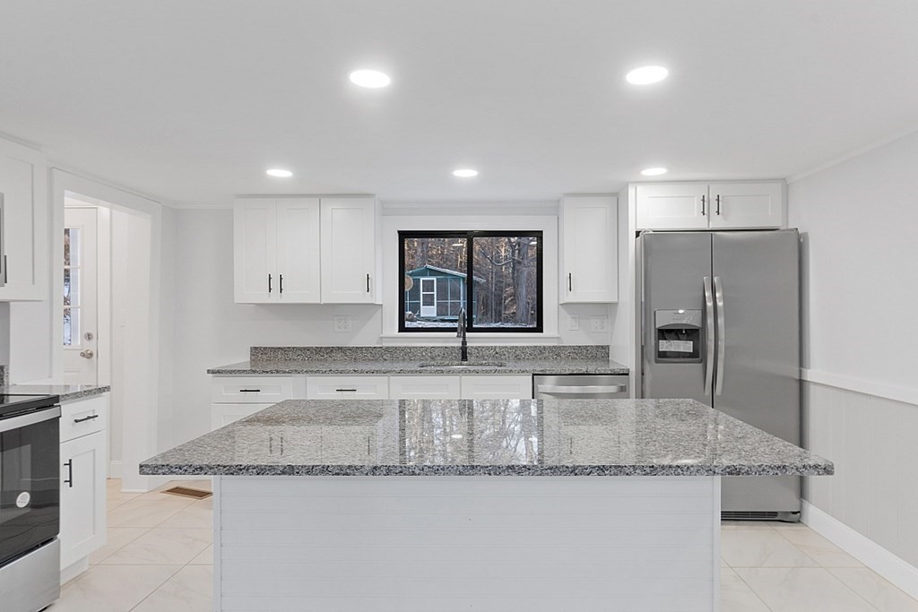 560 County Road Ashby, MA 01431 - Photo 7 of 40 a large kitchen with granite countertop a sink and a refrigerator