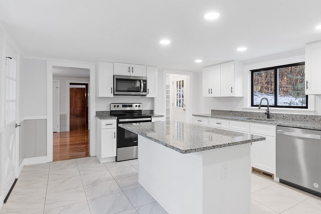 560 County Road Ashby, MA 01431 - Photo 8 of 40 a kitchen with stainless steel appliances granite countertop a sink and a stove