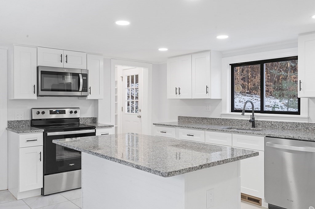 560 County Road Ashby, MA 01431 - Photo 9 of 40 a kitchen with granite countertop a stove sink and microwave