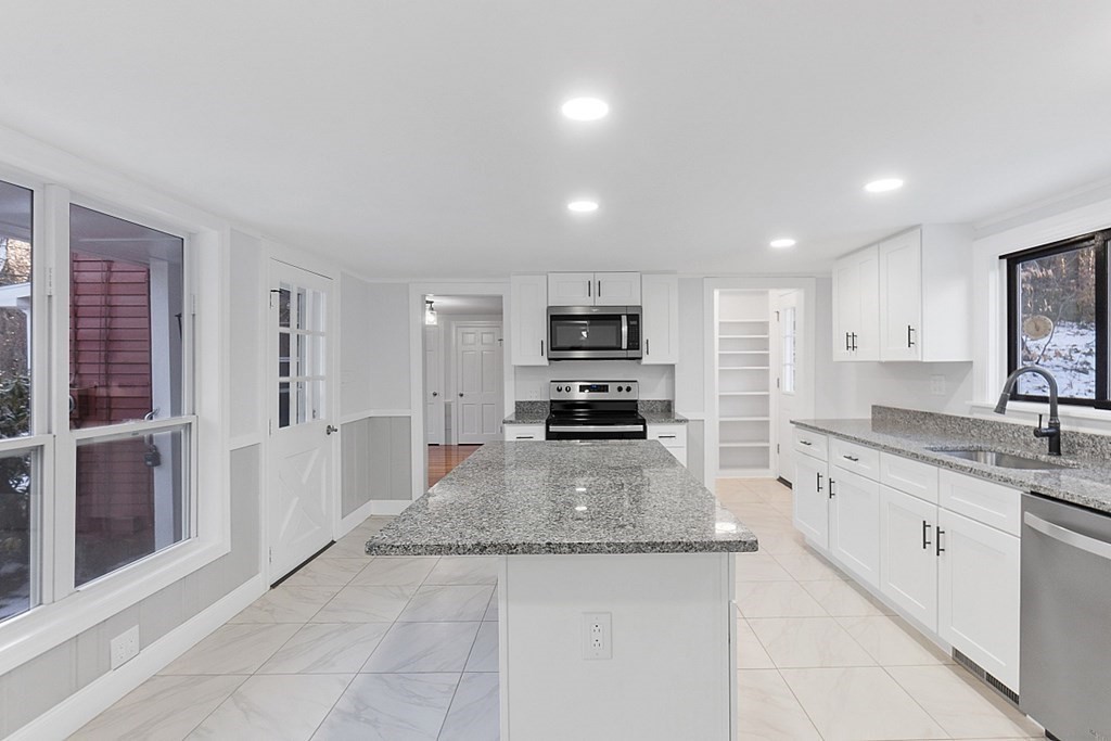 560 County Road Ashby, MA 01431 - Photo 10 of 40 a large kitchen with stainless steel appliances granite countertop a large counter top and a stove top oven