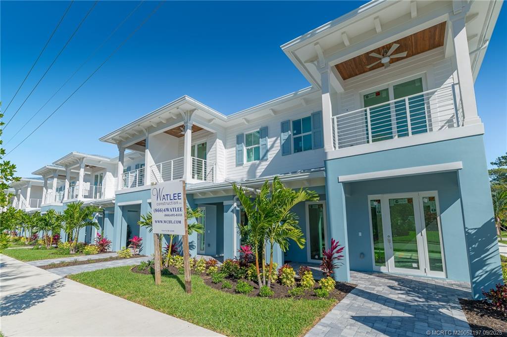 4674 Southeast Manatee Terrace Stuart, FL 34997 - Photo 11 of 55 a front view of a house with a yard table and chairs