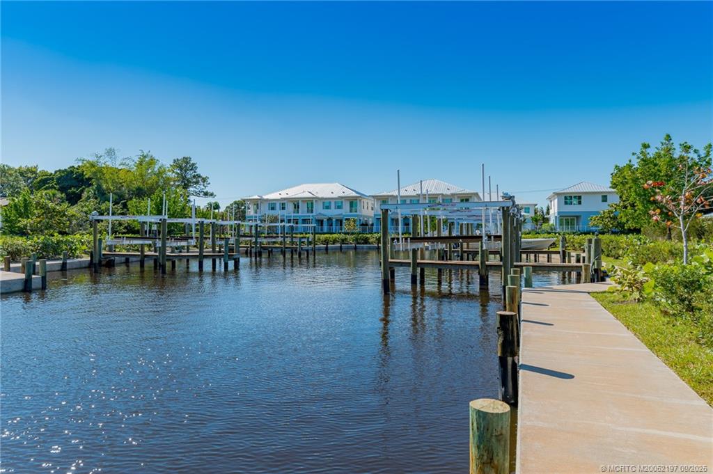 4674 Southeast Manatee Terrace Stuart, FL 34997 - Photo 17 of 55 a view of a lake with outdoor seating space