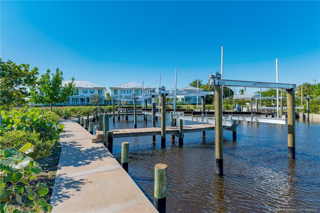 4674 Southeast Manatee Terrace Stuart, FL 34997 - Photo 19 of 55 a view of a balcony with floor to ceiling windows and wooden floor