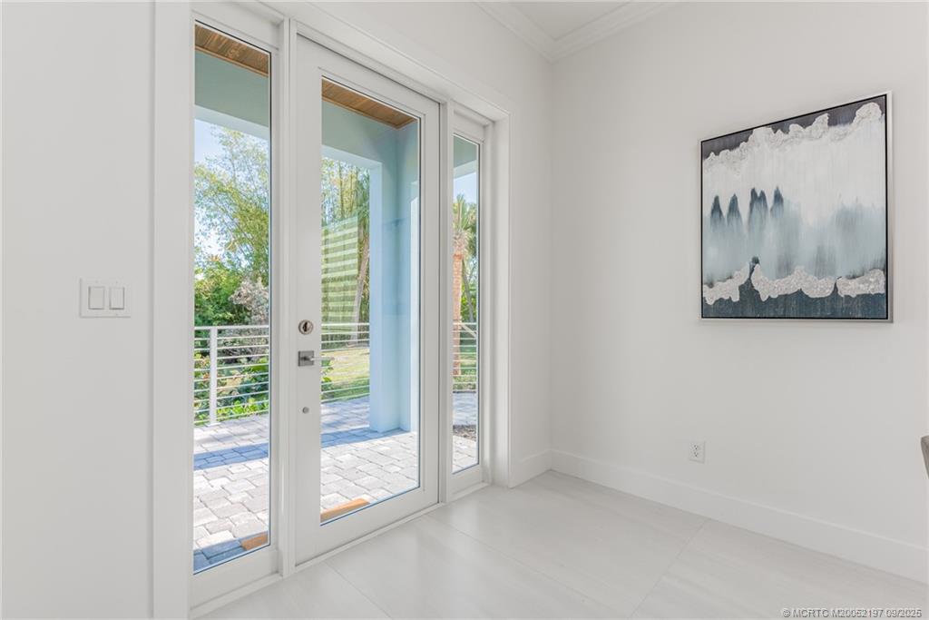 4674 Southeast Manatee Terrace Stuart, FL 34997 - Photo 27 of 55 an empty room with a large window