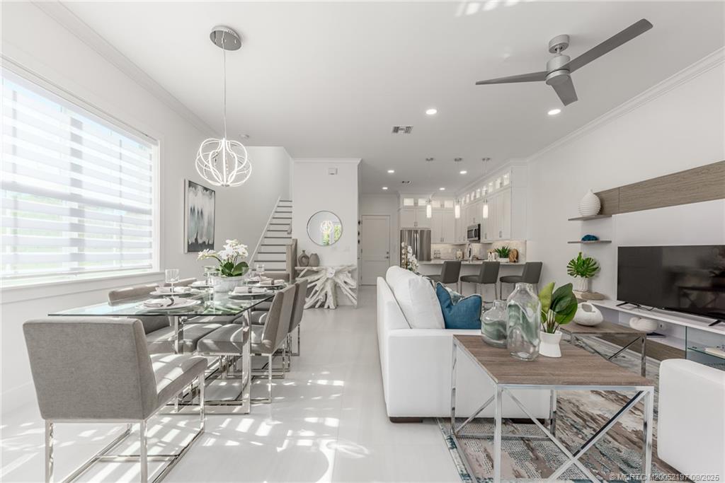 4674 Southeast Manatee Terrace Stuart, FL 34997 - Photo 28 of 55 a view of a dining room with furniture window and outside view