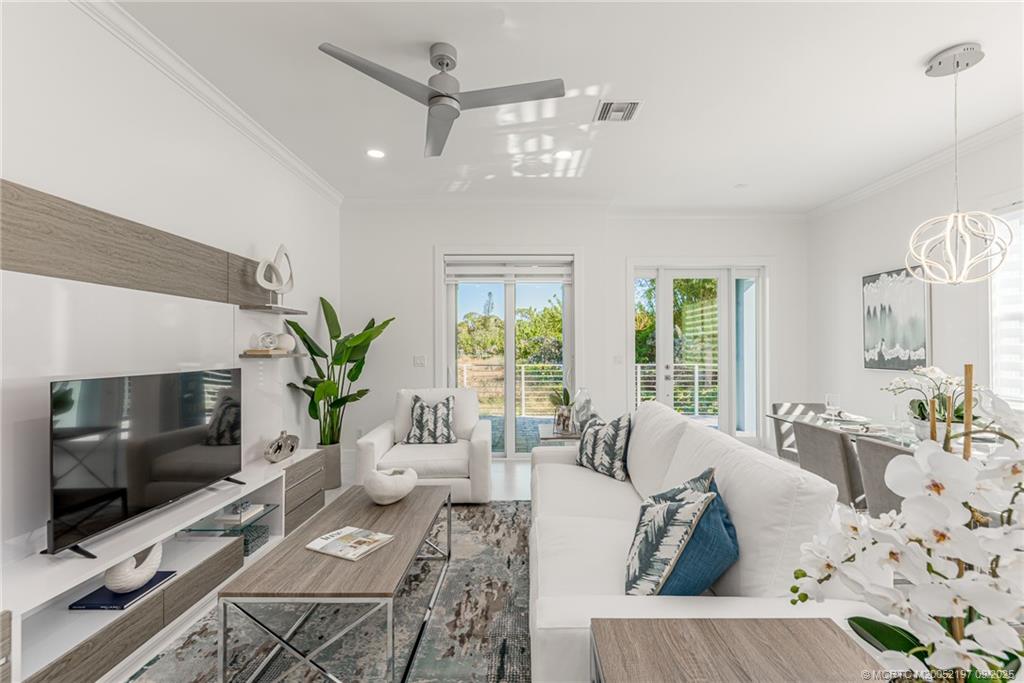 4674 Southeast Manatee Terrace Stuart, FL 34997 - Photo 30 of 55 a living room with furniture and a flat screen tv