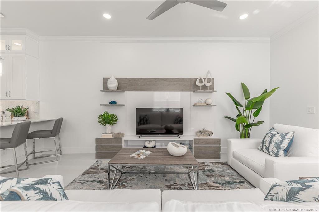 4674 Southeast Manatee Terrace Stuart, FL 34997 - Photo 31 of 55 a living room with furniture and a potted plant