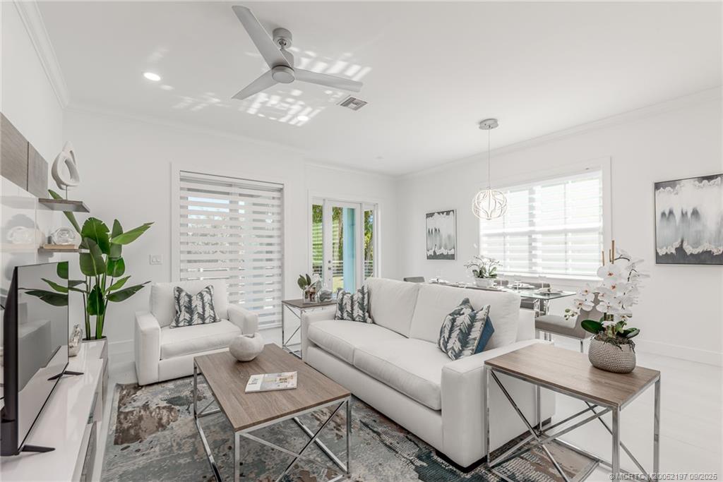 4674 Southeast Manatee Terrace Stuart, FL 34997 - Photo 32 of 55 a living room with furniture and a large window