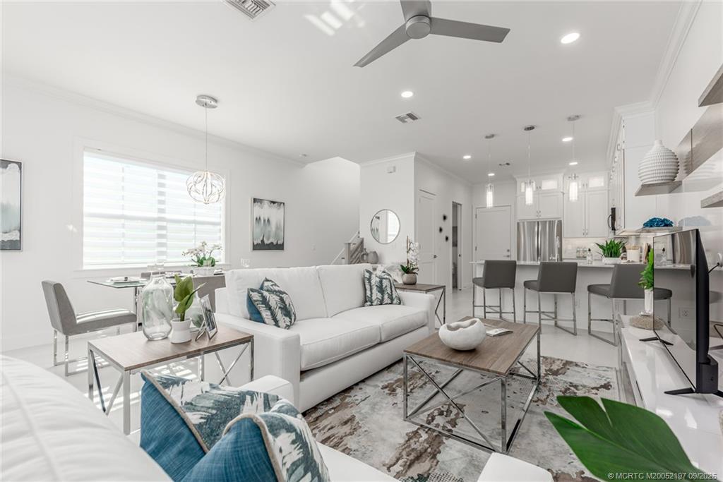 4674 Southeast Manatee Terrace Stuart, FL 34997 - Photo 33 of 55 a living room with furniture and a large window