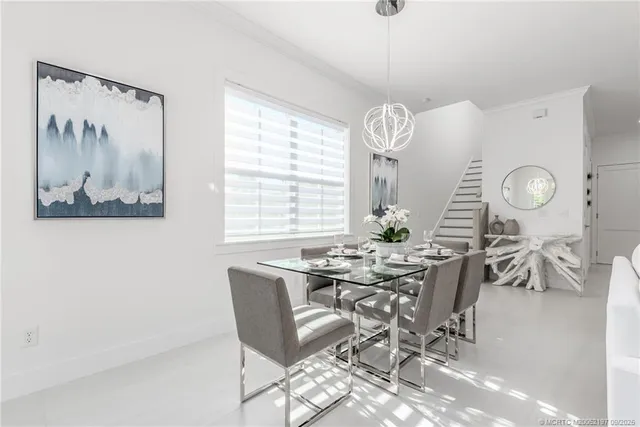 a kitchen with a sink dishwasher stove and white cabinets with wooden floor