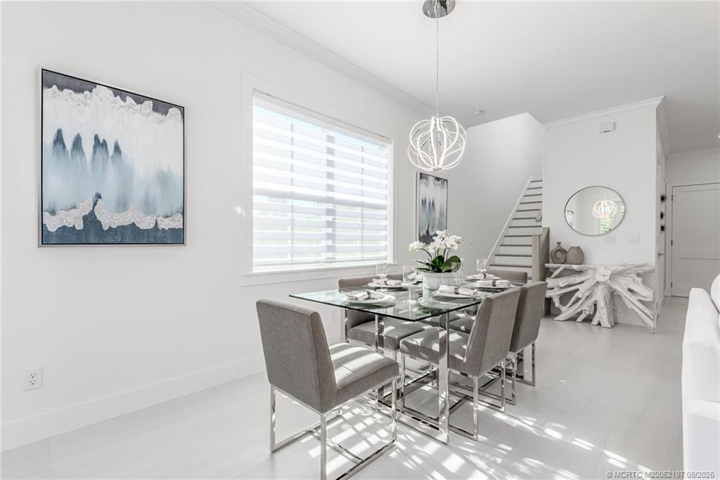 4674 Southeast Manatee Terrace Stuart, FL 34997 - Photo 34 of 55 a view of a dining room filled with furniture and window
