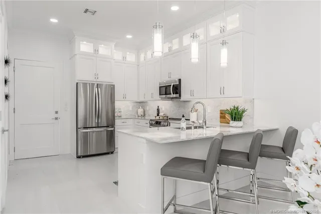 a spacious bathroom with a granite countertop sink and a mirror