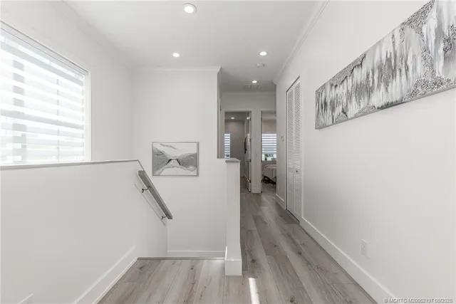 a bedroom with a bed a chandelier and mirror