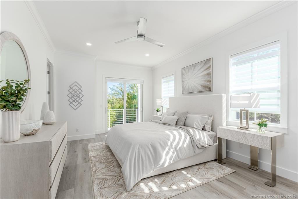 4674 Southeast Manatee Terrace Stuart, FL 34997 - Photo 46 of 55 a bedroom with a bed and a potted plant