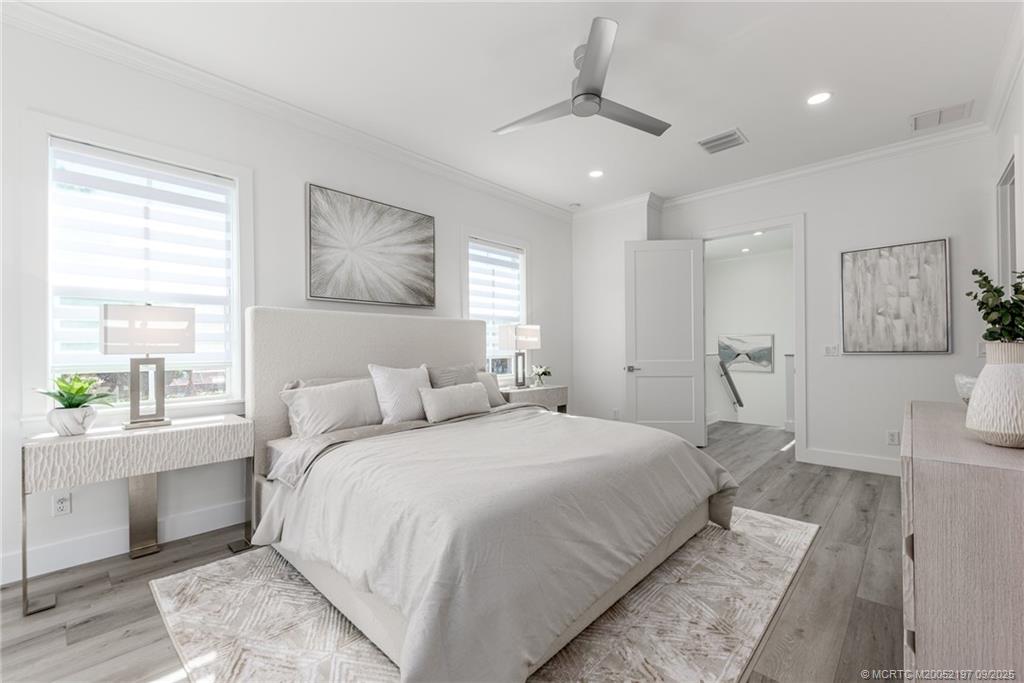 4674 Southeast Manatee Terrace Stuart, FL 34997 - Photo 47 of 55 a bedroom with a large bed and a window