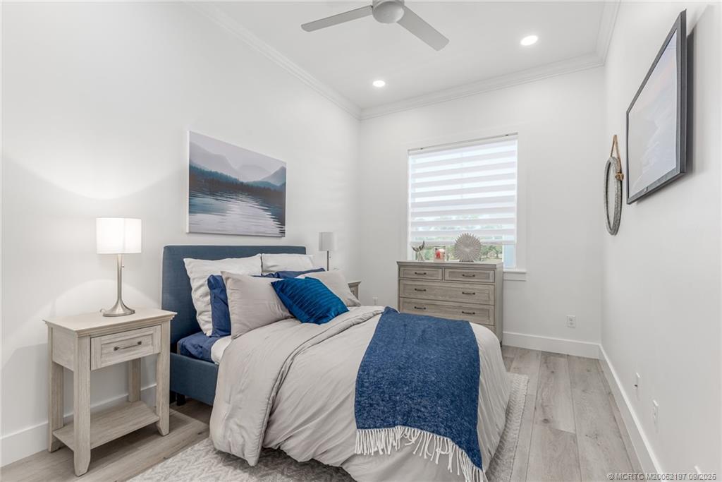 4674 Southeast Manatee Terrace Stuart, FL 34997 - Photo 8 of 55 a bedroom with a bed and a window