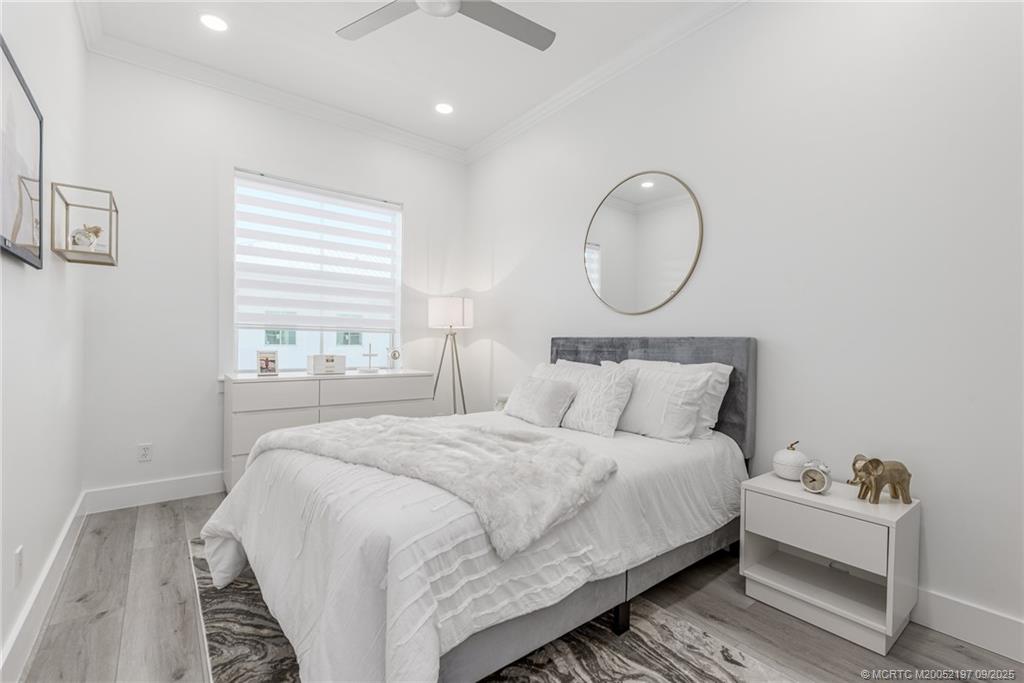 4674 Southeast Manatee Terrace Stuart, FL 34997 - Photo 10 of 55 a bedroom with bed and a window