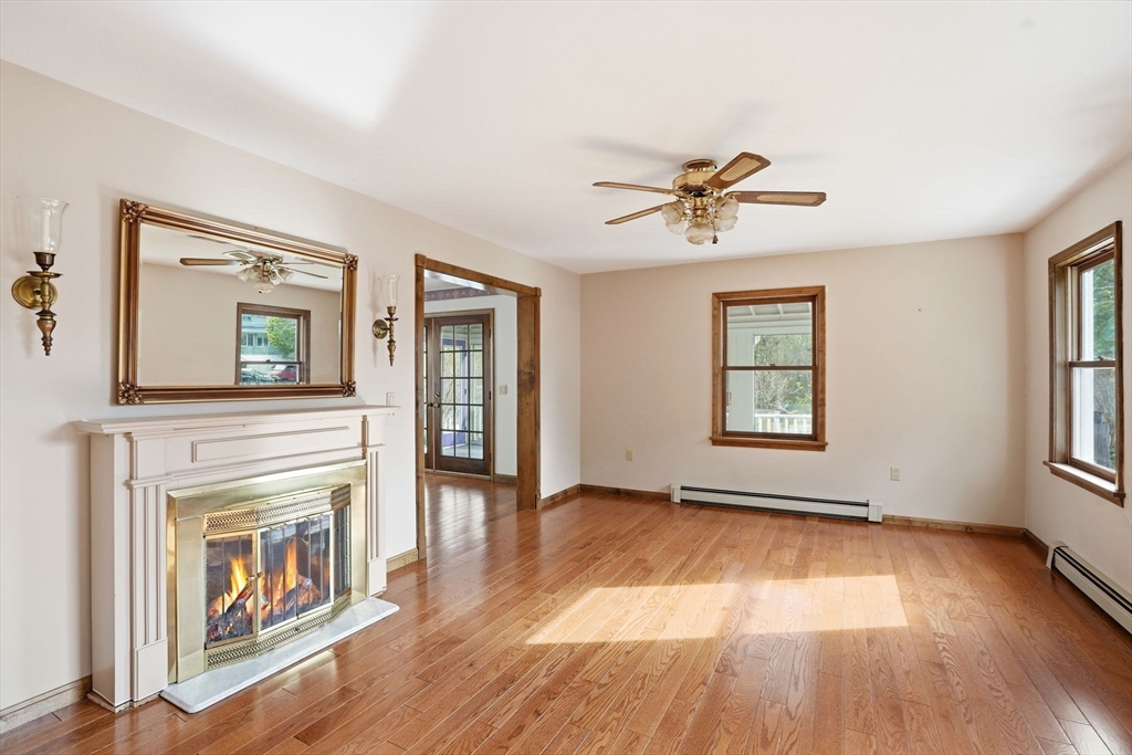 67 Wituwamat Road Weymouth, MA 02191 - Photo 3 of 42 an empty room with wooden floor a ceiling fan and windows