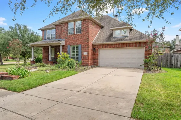 a bedroom with a bed and a table chair