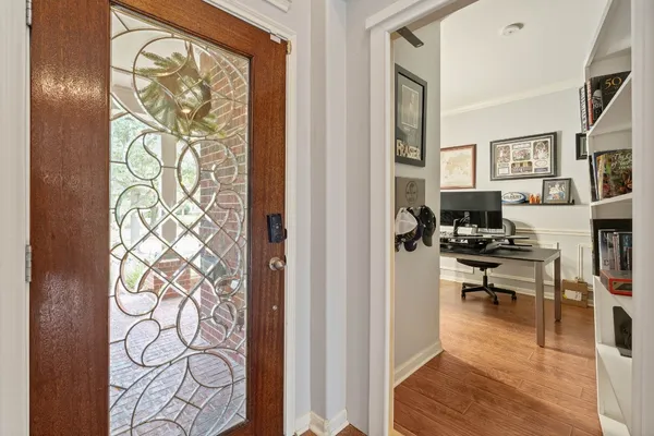 a kitchen with granite countertop white cabinets and stainless steel appliances