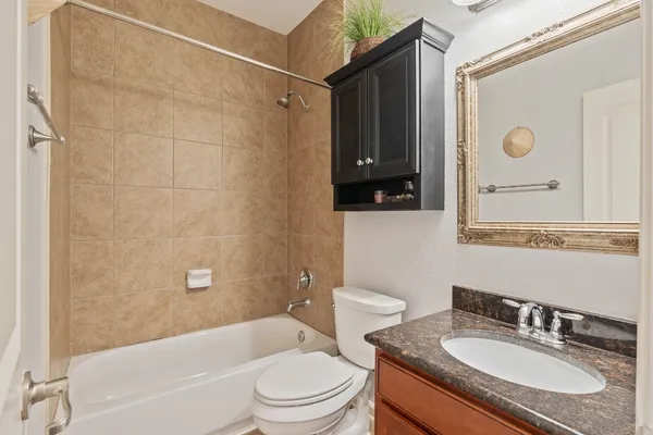 a bathroom with a bathtub a double vanity sink and a mirror