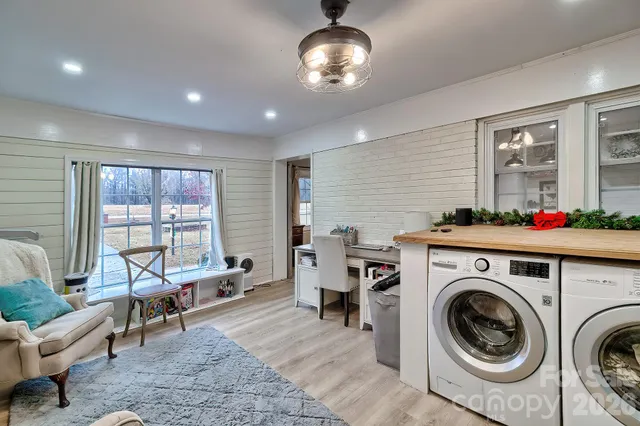 a living room with furniture and a floor to ceiling window