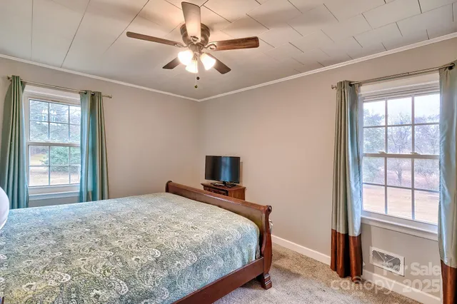 a bedroom with a large bed and a tv