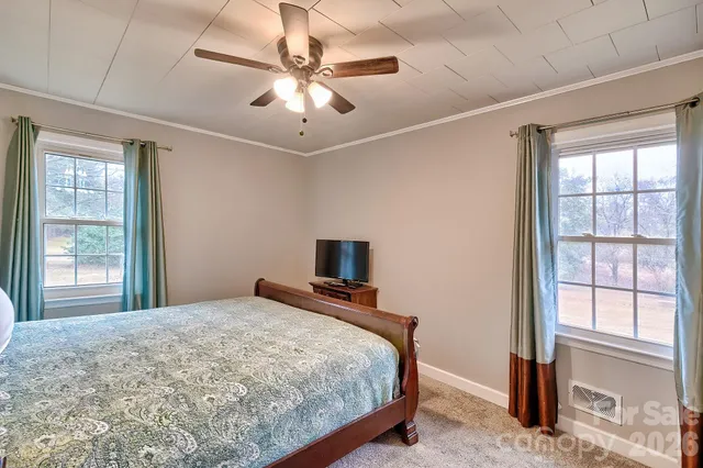 a bedroom with a large bed and a tv