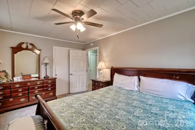 a bedroom with a bed and a chandelier