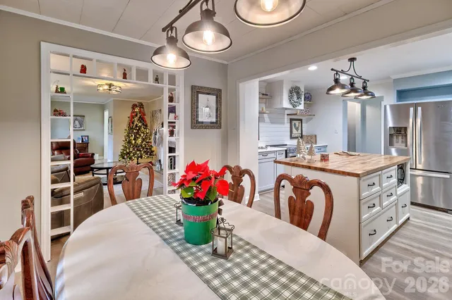 a view of a dining room with furniture and chandelier