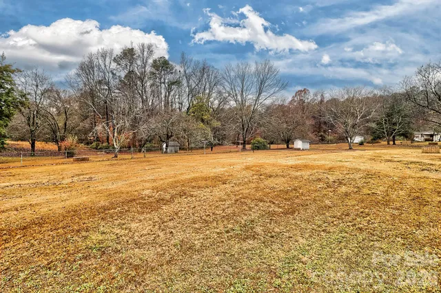 a spacious bedroom with a large bed and a dresser