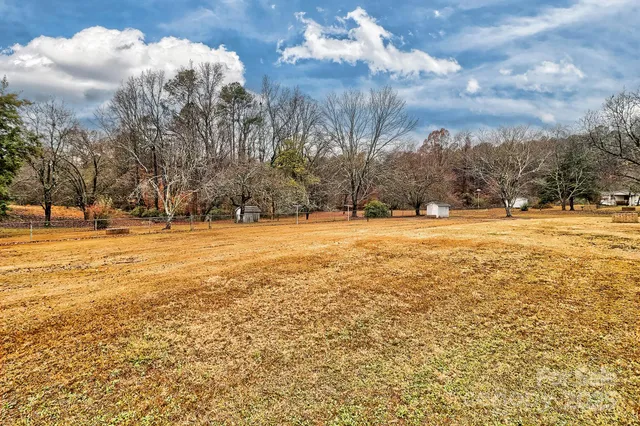 a spacious bedroom with a large bed and a dresser