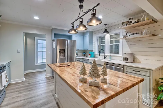 a kitchen with stainless steel appliances granite countertop a sink and a stove