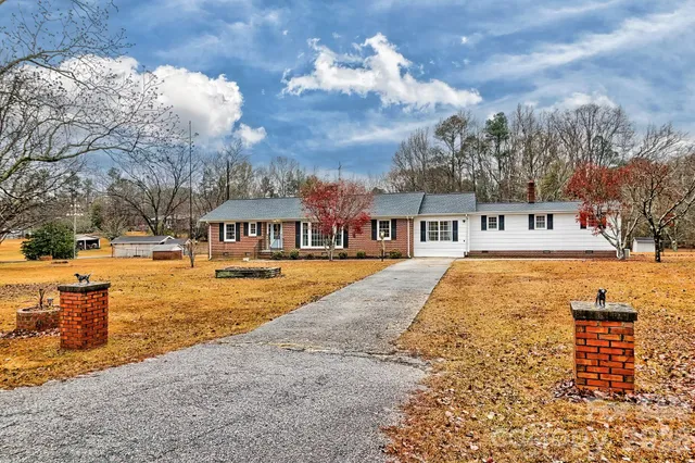 a view of a house with snow on the side of road