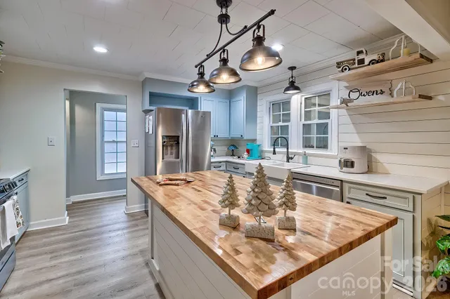 a kitchen with stainless steel appliances granite countertop a sink and a stove