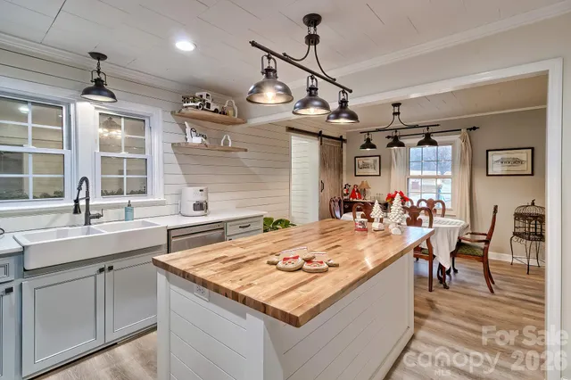 a kitchen with a stove a counter space a sink and dishwasher